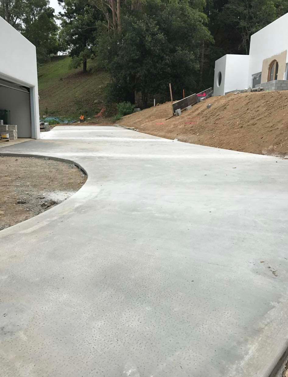Concrete Driveway Leading To A Garage And A House — Providing Steel & Concrete Construction In Gold Coast, QLD