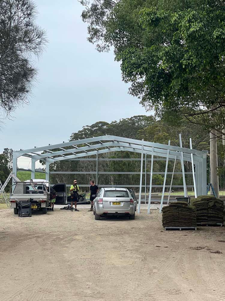 Car Parked In Front Of A Building Under Construction — Providing Steel & Concrete Construction In Eviron, NSW