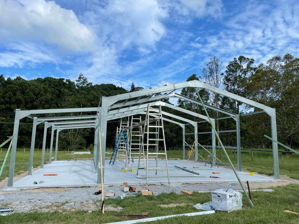 Large Metal Structure Is Being Built In A Field — Providing Steel & Concrete Construction In Byron Bay, NSW