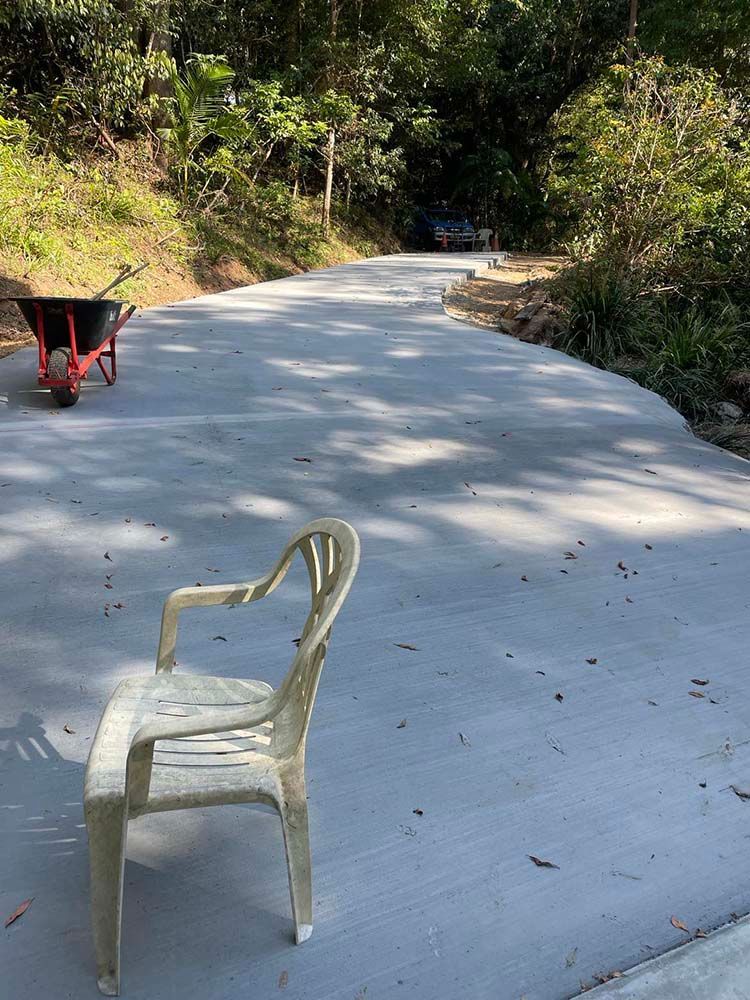 Chair Is Sitting On The Side Of A Road Next To A Wheelbarrow — Providing Steel & Concrete Construction In Eviron, NSW