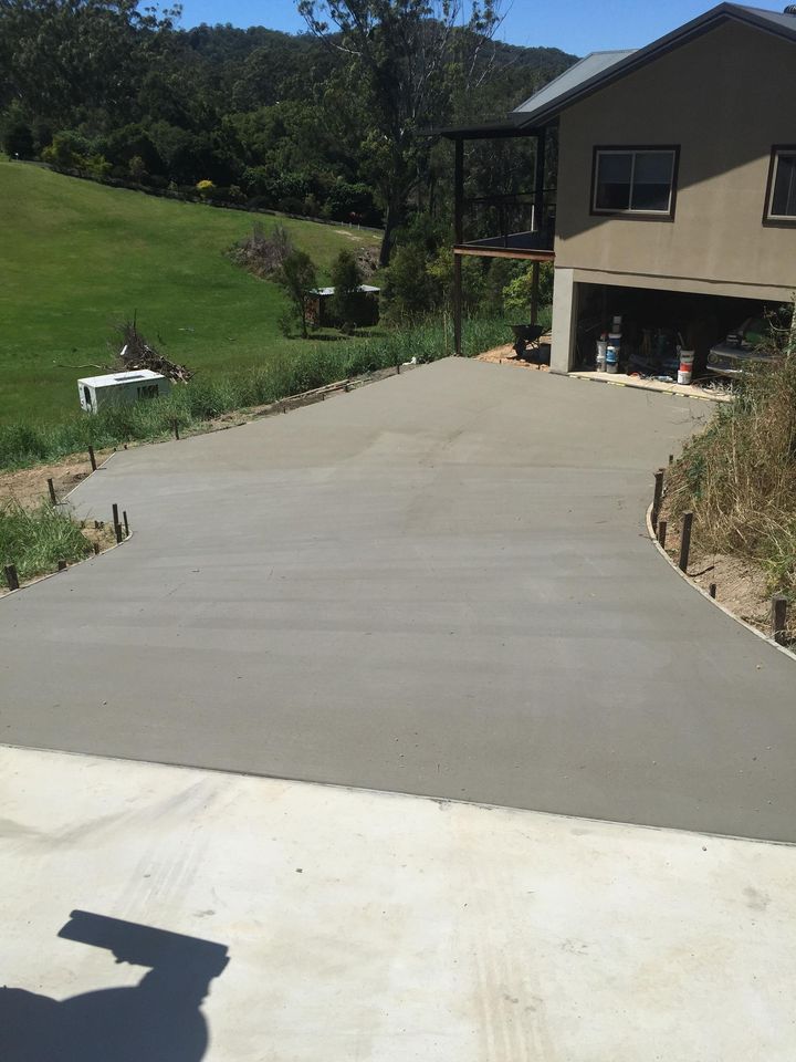 A Concrete Driveway is Being Built in Front of a House — Providing Steel & Concrete Construction In Eviron, NSW