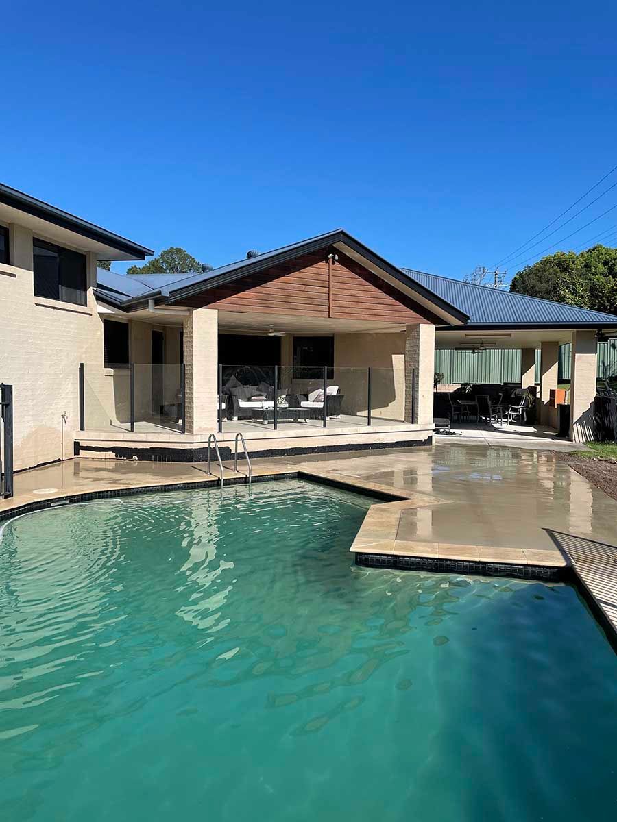 House With A Large Swimming Pool In Front Of It — Providing Steel & Concrete Construction In Lismore, NSW