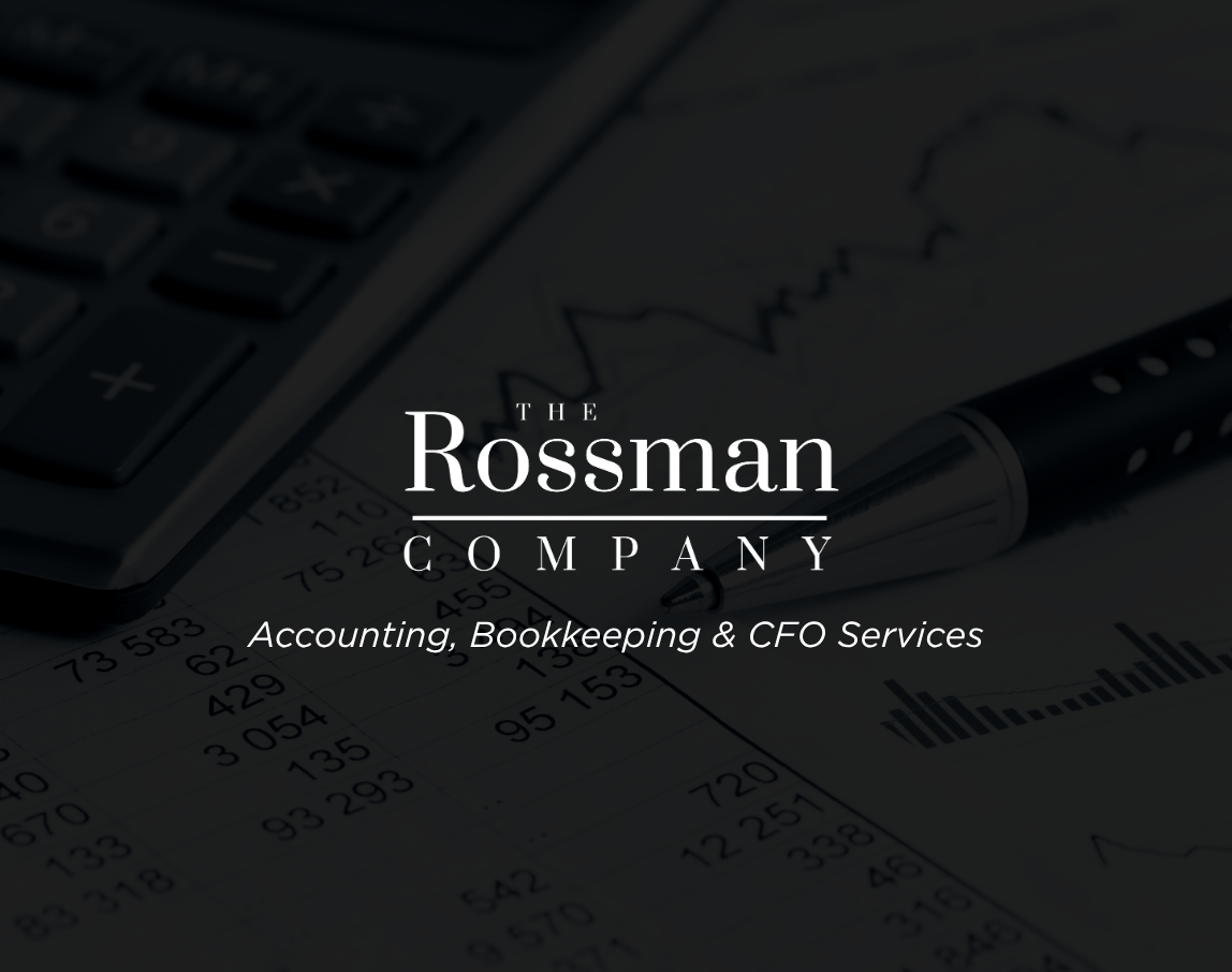 A woman wearing headphones is working on a computer with the rossman company logo in the background