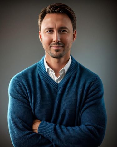A man in a blue sweater with his arms crossed