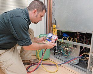 Man Installing Air Condition Using Electrical Cable — Beaver Falls, PA — Johnson’s Heating & Cooling, LLC