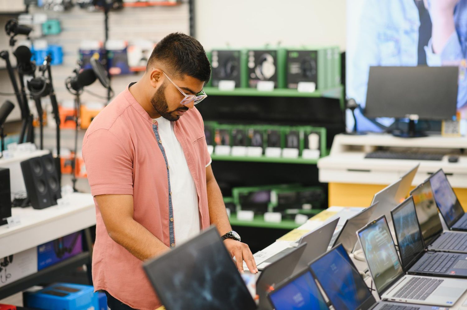 Person using a calculator with a pen, working on documents.