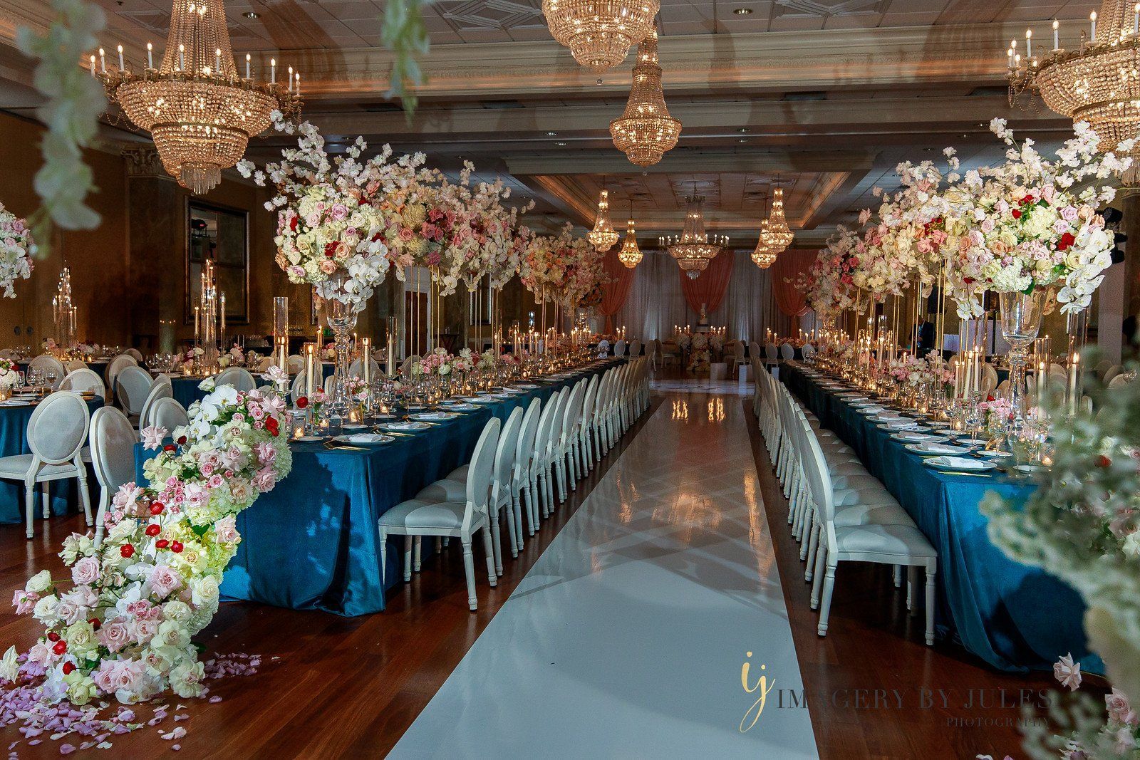 a large room filled with tables and chairs and flowers .