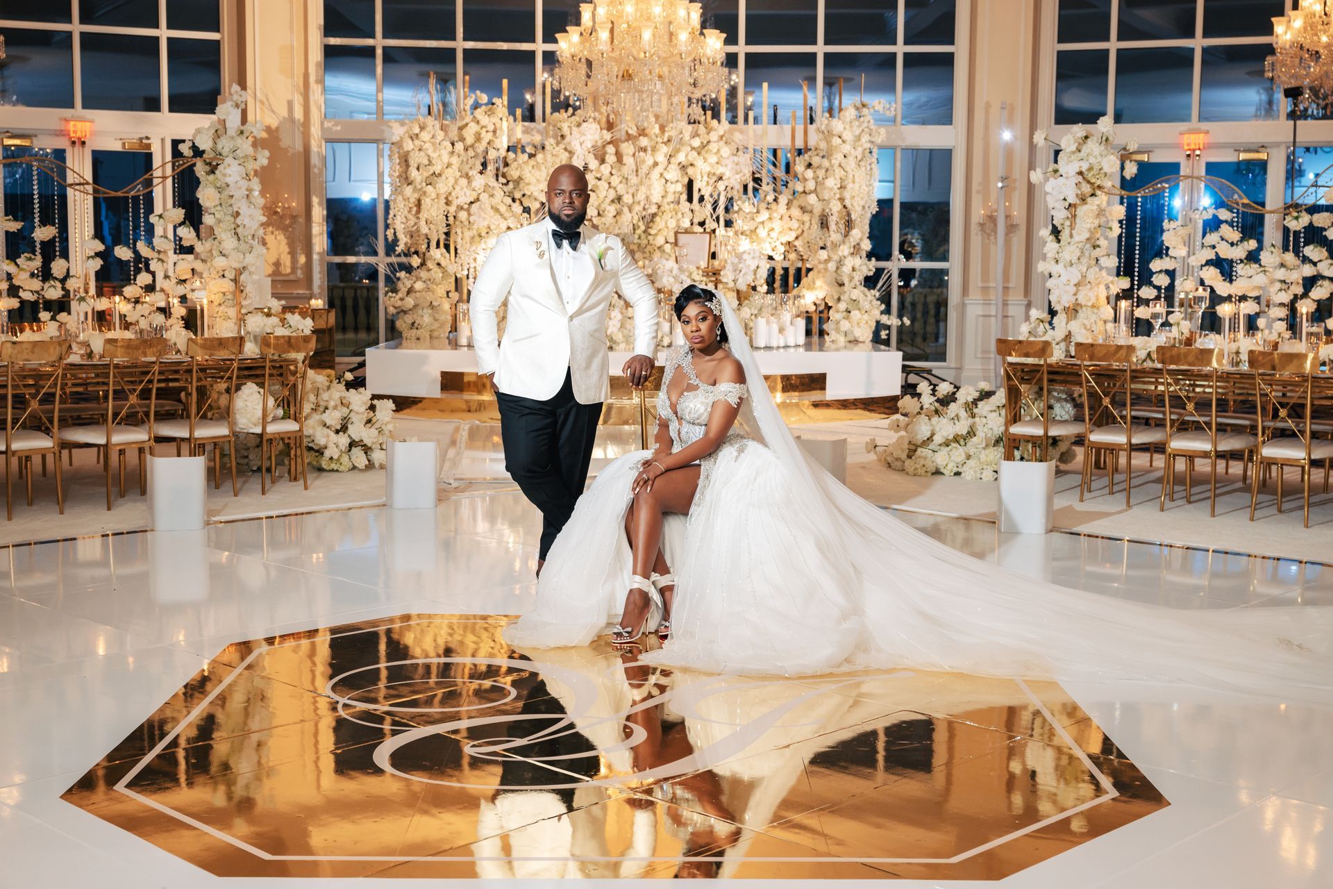 a bride and groom are posing for a picture in a large room .