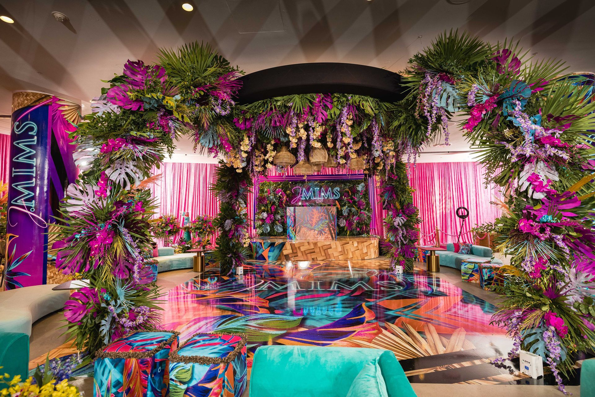 a room with a lot of flowers on the floor and a stage .