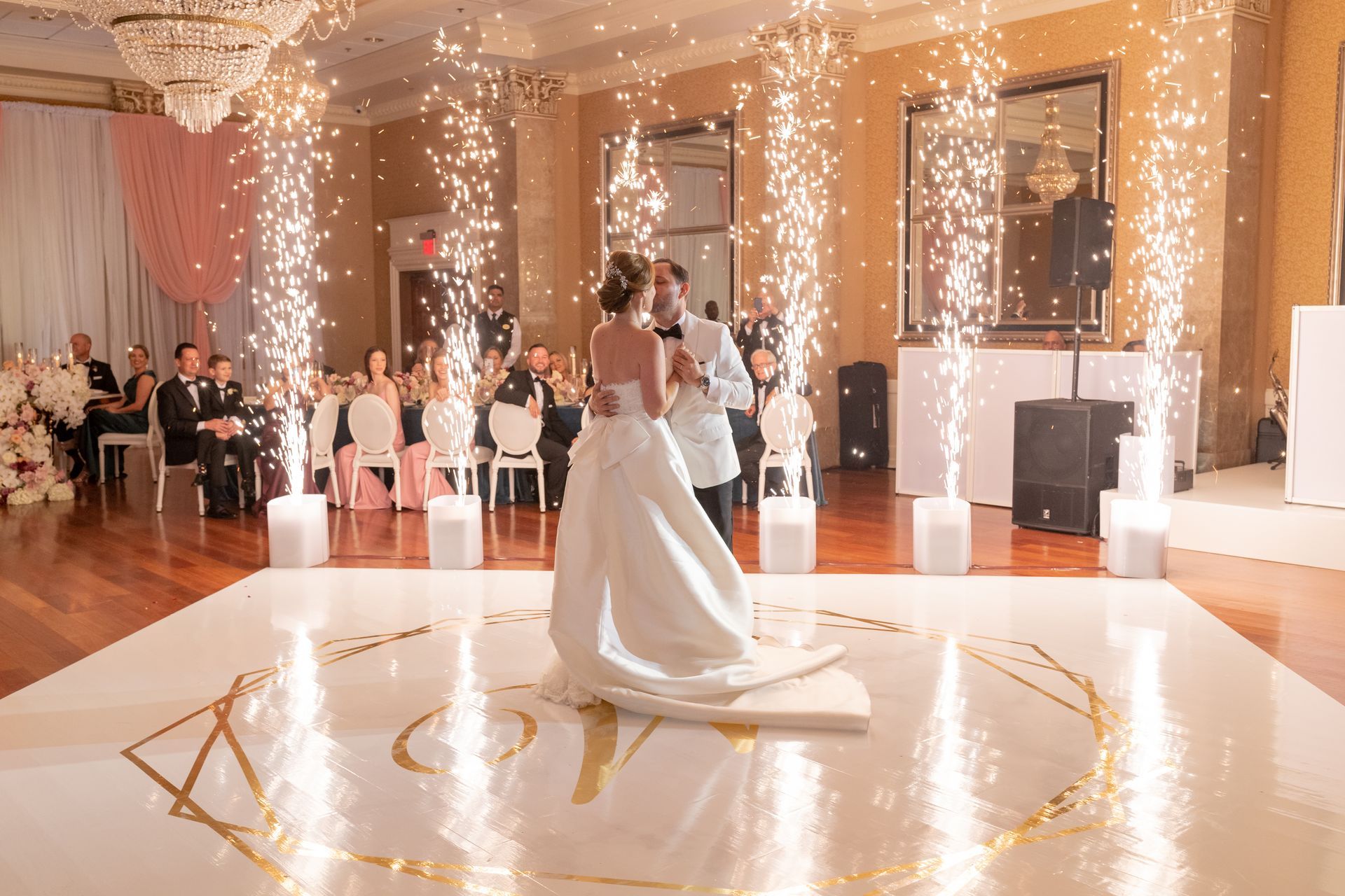 a bride and groom are dancing on a dance floor at their wedding reception .