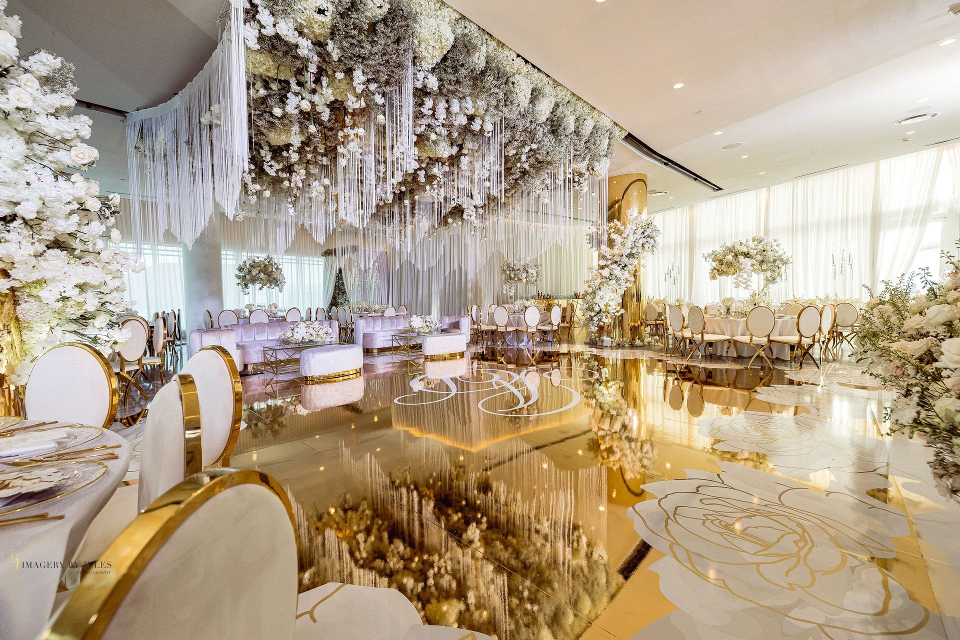 a large room with tables and chairs and a mirrored floor .