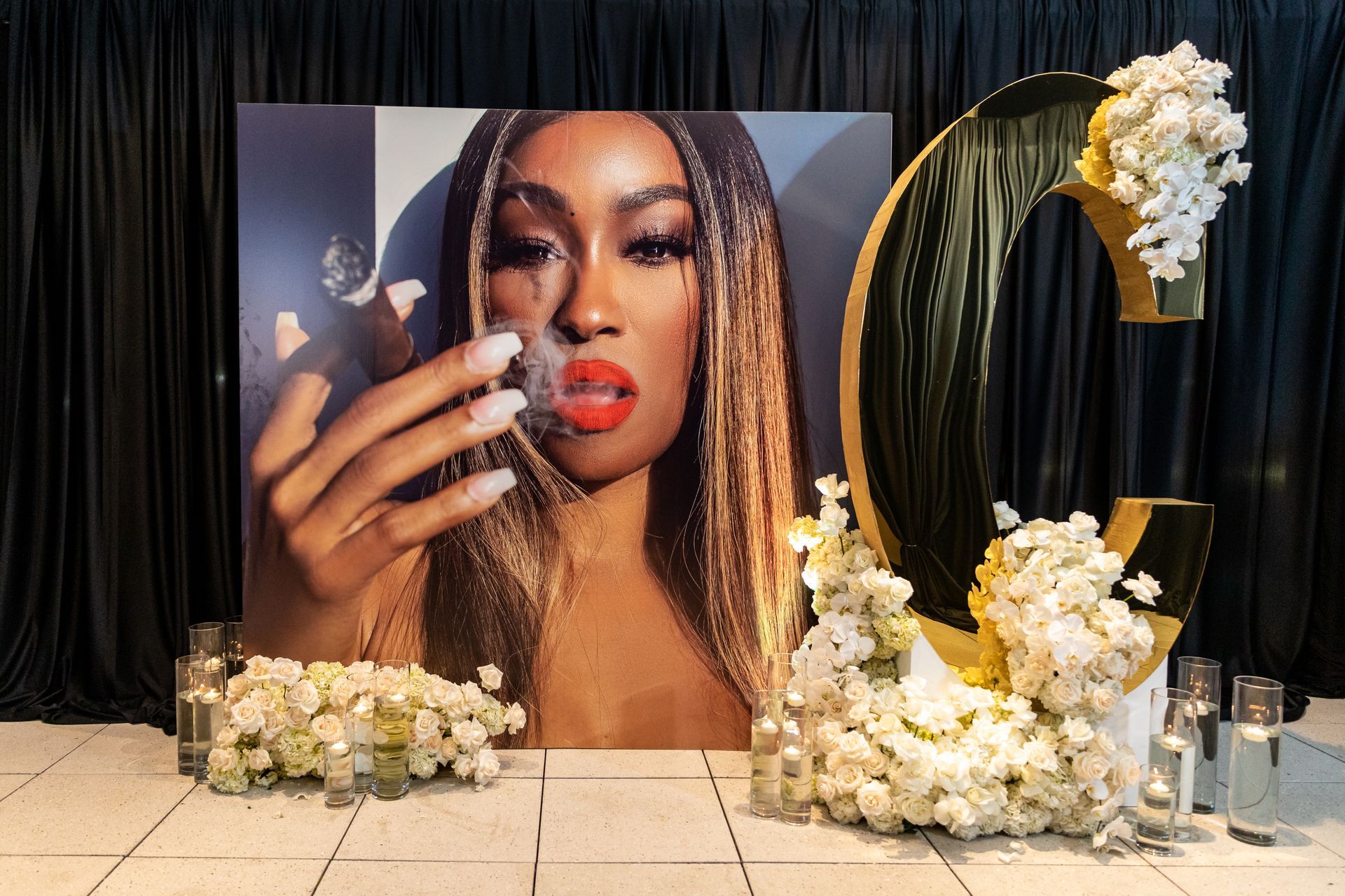 there is a large picture of a woman holding a glass of wine .