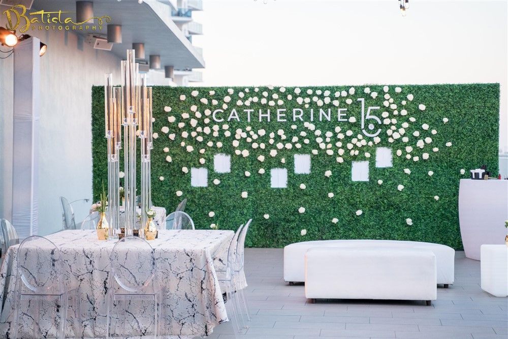 a table and chairs are sitting in front of a green wall .