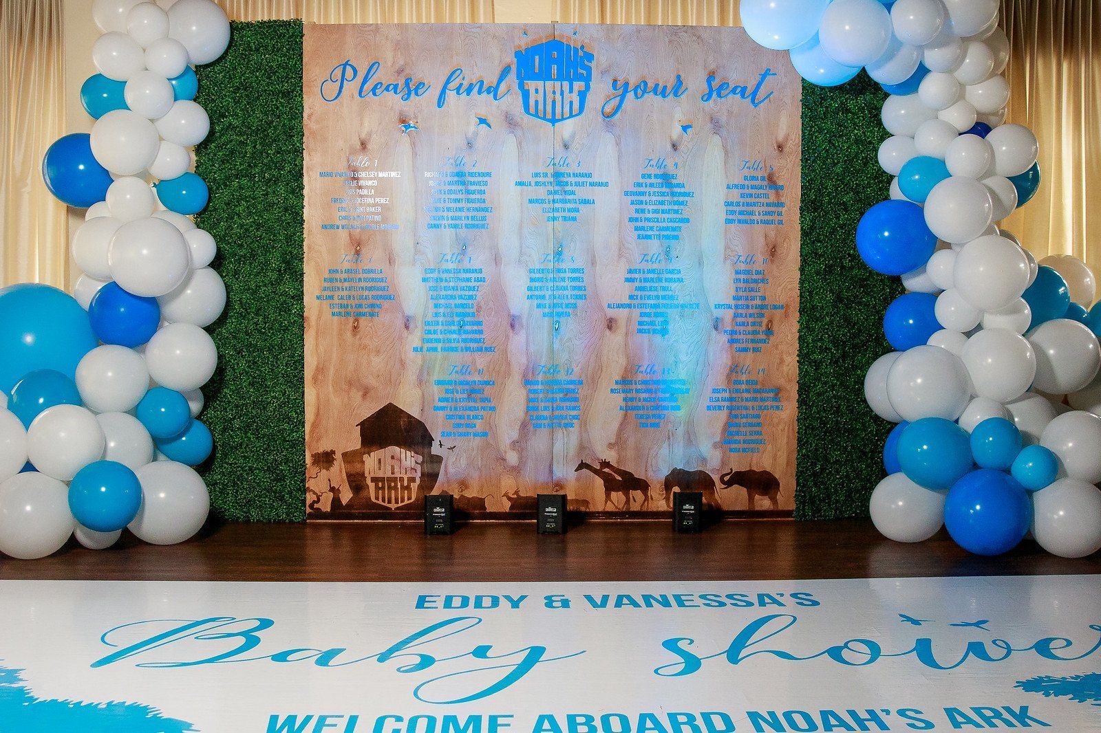 a baby shower is being held in a room with blue and white balloons .