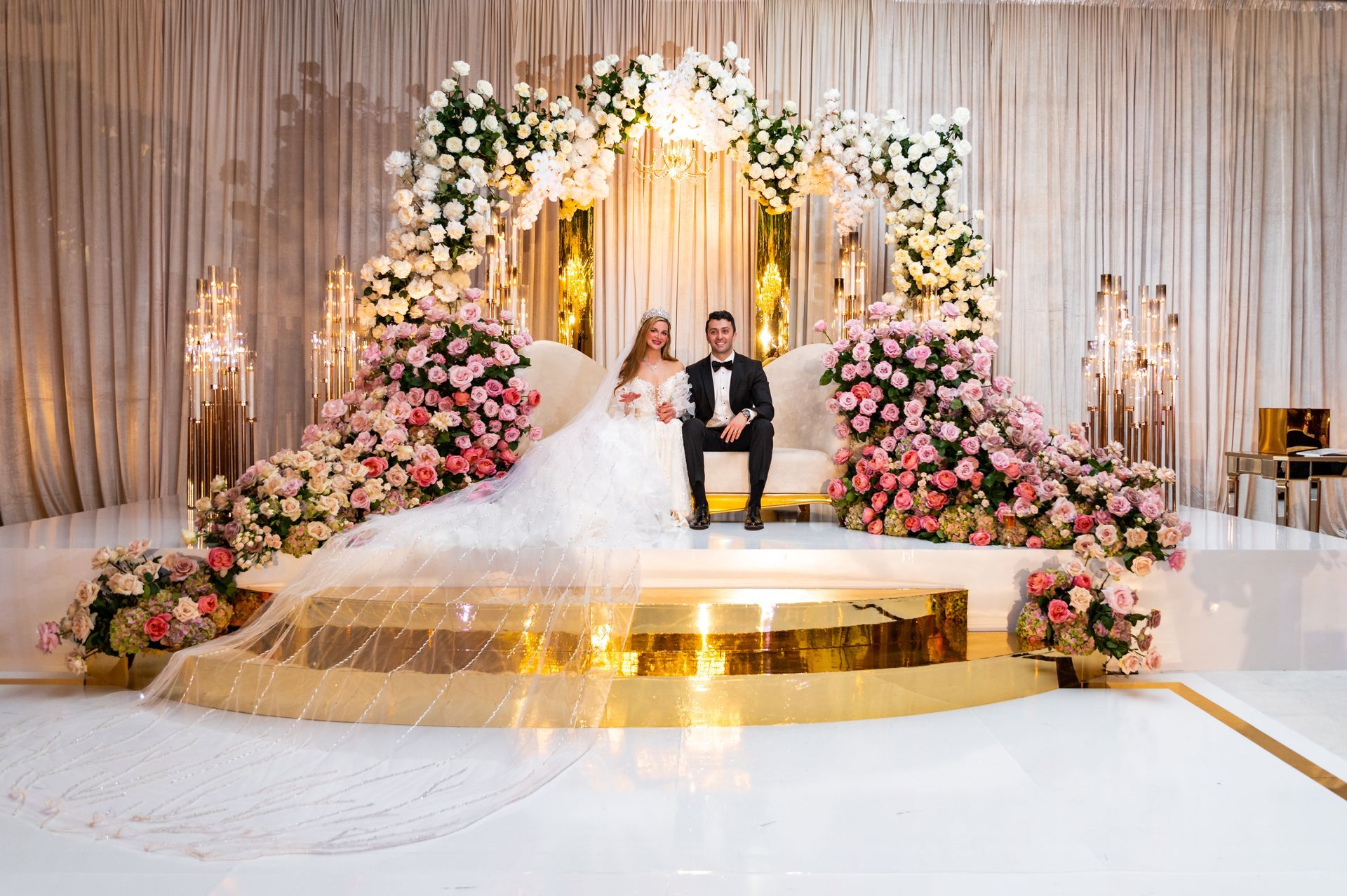 a bride and groom are dancing on stilts at a wedding reception .