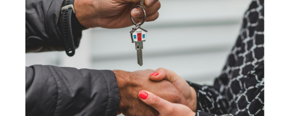 Couple getting house keys from sell of home