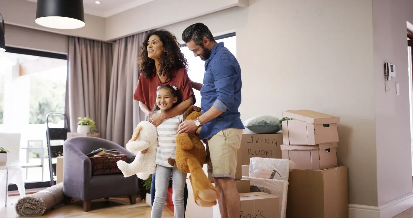 Family with moving boxes around them excited to sell their house!