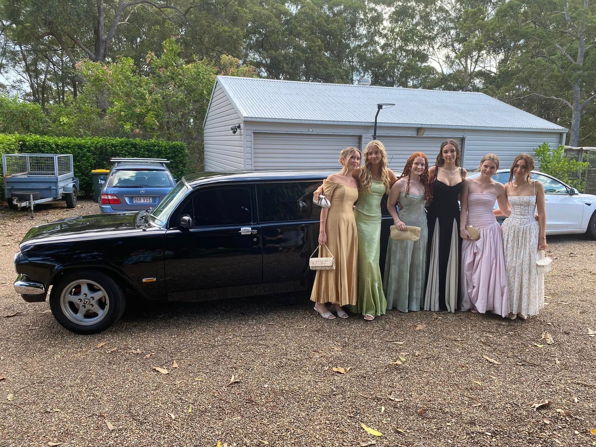 A Group of Women Are Posing for a Picture in a Black Limousine — Noosa Premier Stretch Holden Transfers In Sunrise Beach, QLD