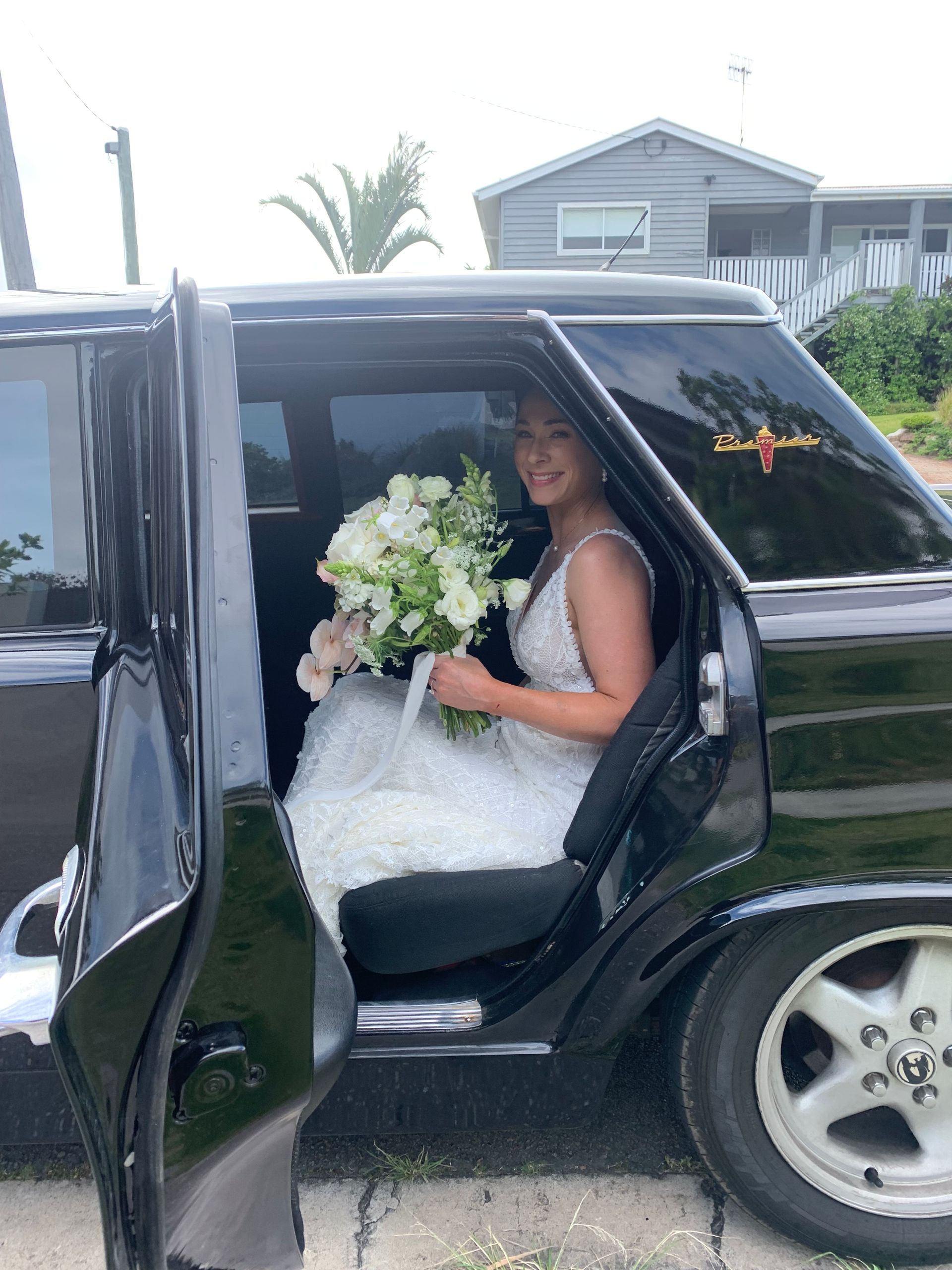 A White Limousine Is Parked On The Side Of The Road — Noosa Premier Stretch Holden Transfers In Sunrise Beach, QLD