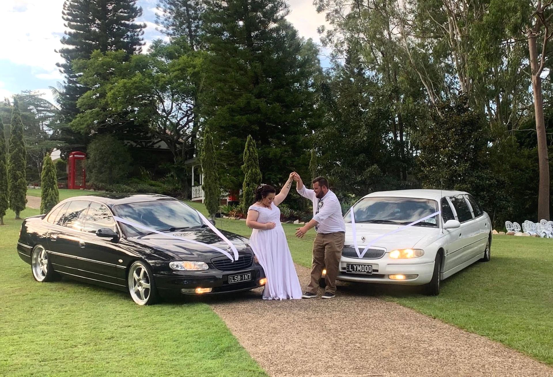 Bride And Groom Dancing Next To A Car — Noosa Premier Stretch Holden Transfers In Sunrise Beach, QLD