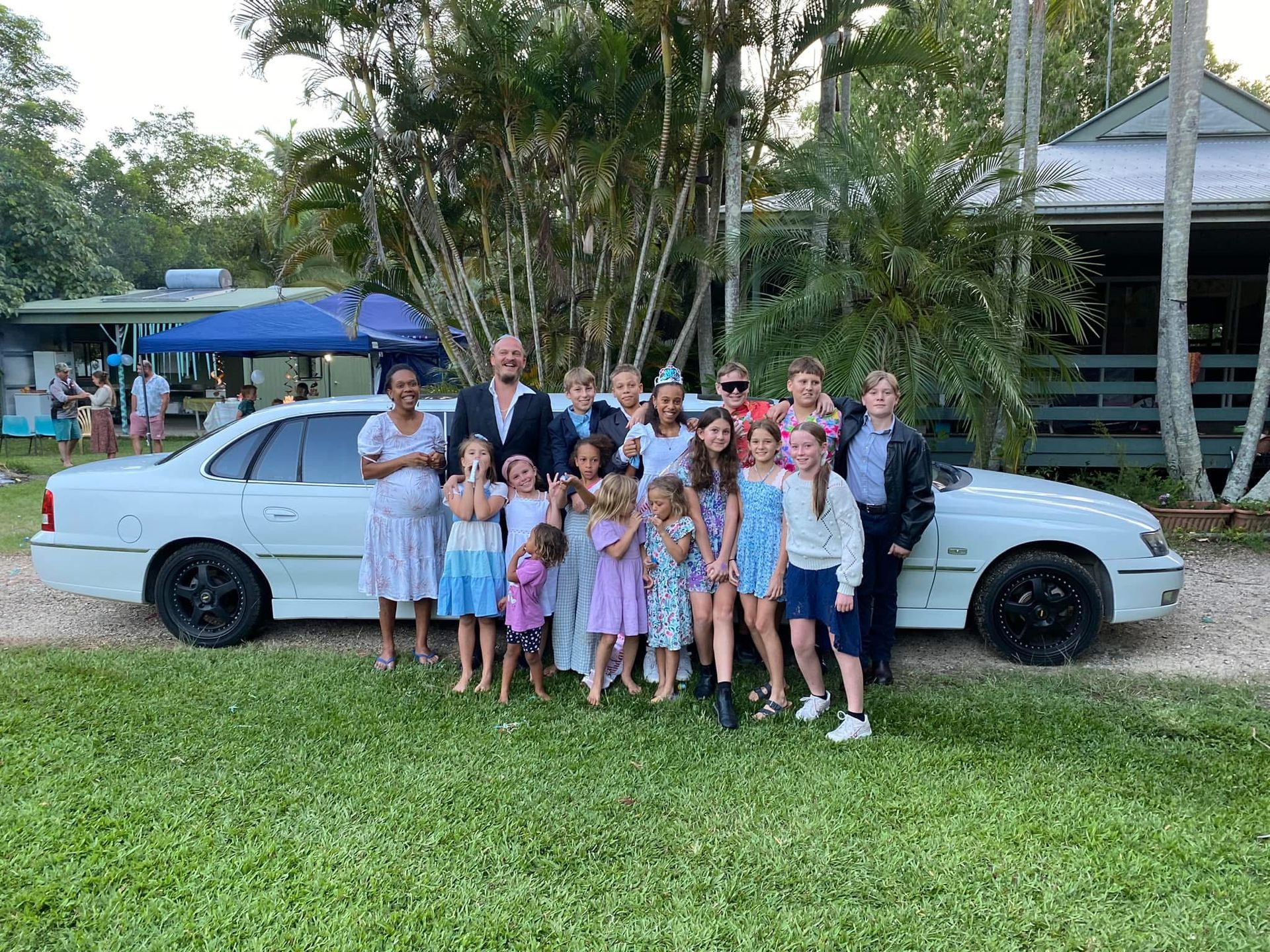 Big Family At An Event Smiling In Front of Car - Noosa Premier Stretch Holden Transfers In Sunrise Beach, QLD