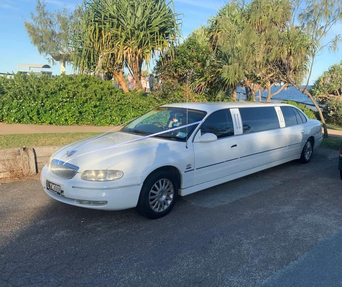 A White Limousine Is Parked On The Side Of The Road — Noosa Premier Stretch Holden Transfers In Sunrise Beach, QLD