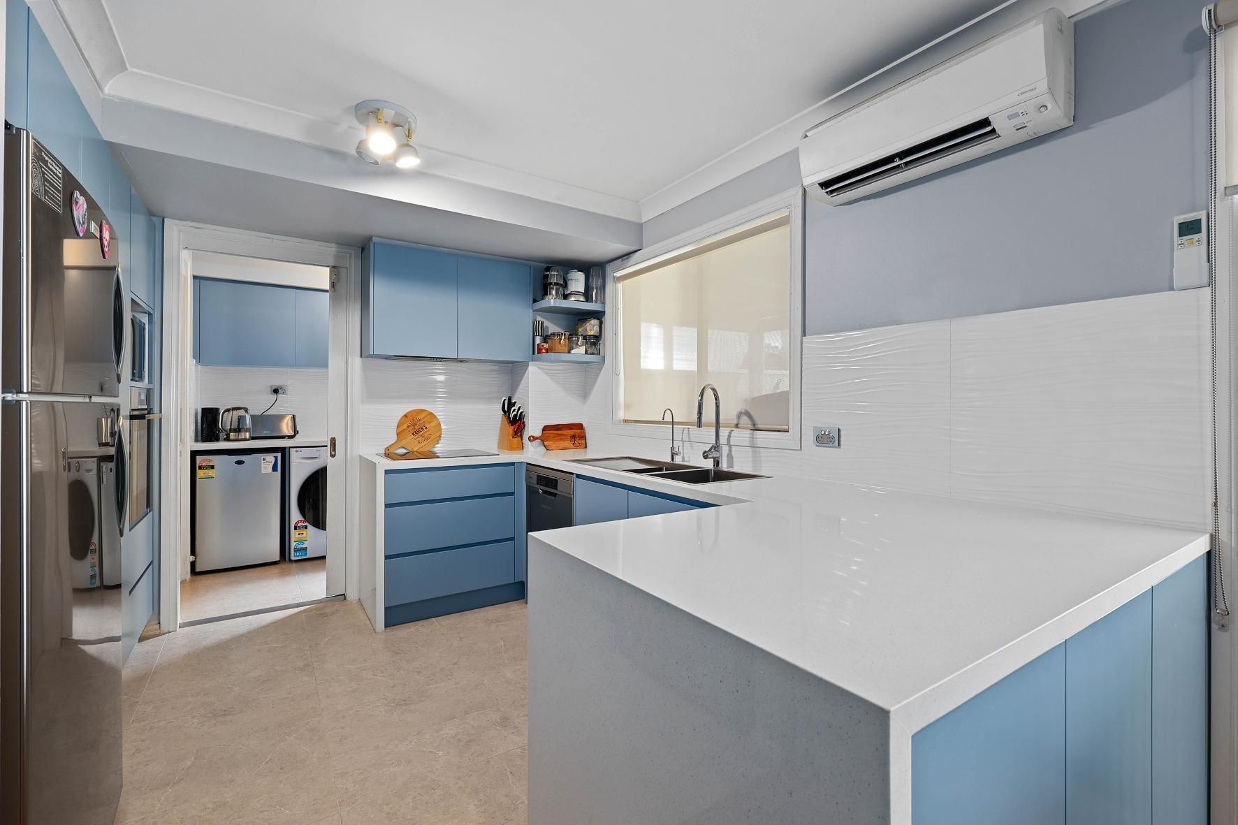 Blue and White Kitchen with Island, Cabinets, and Appliances — Above & Beyond Interiors Custom Joinery in Macquarie Fields, NSW