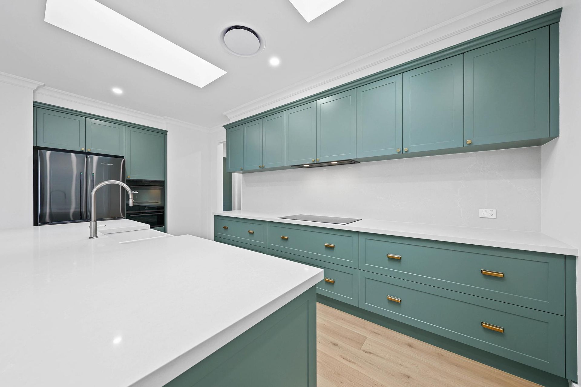 Green Kitchen Cabinets with White Countertops and Island — Above & Beyond Interiors Custom Joinery in Appin, NSW