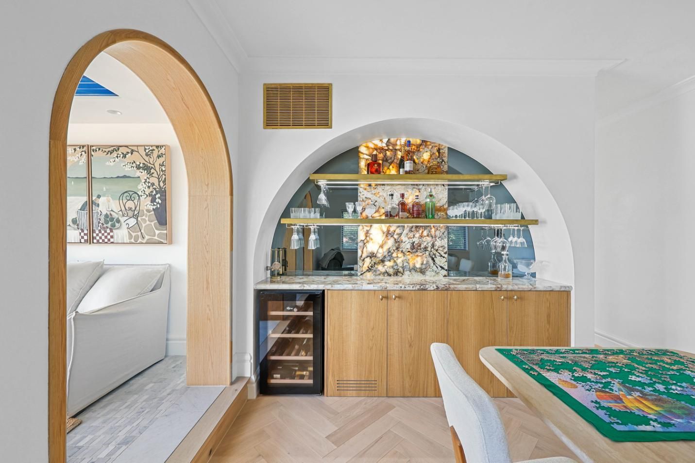 A Built-In Bar with Wine Fridge and Arched Display in A White-Walled Dining Area — Above & Beyond Interiors Custom Joinery in Double Bay, NSW
