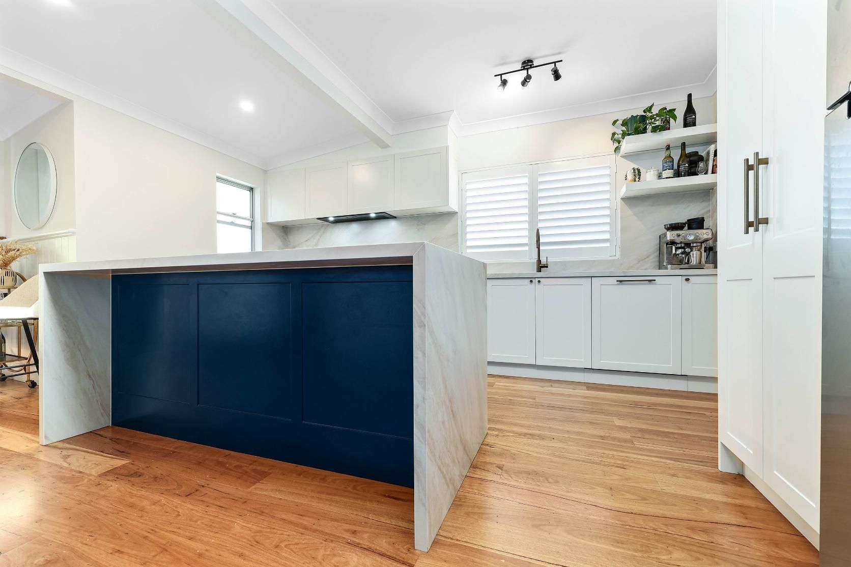 Modern Kitchen with Blue Island, White Cabinets, Hardwood Floors — Above & Beyond Interiors Custom Joinery in Bellambi, NSW