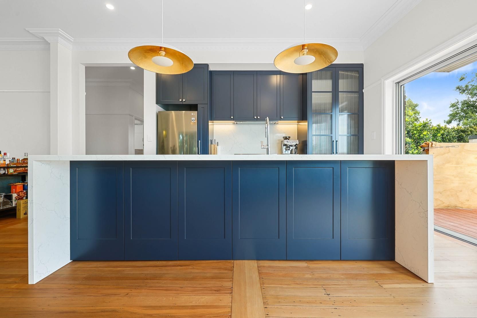 Modern Blue Kitchen Island with White Countertop, Gold Pendant Lights, and Hardwood Floor — Above & Beyond Interiors Custom Joinery in Lilyfield, NSW