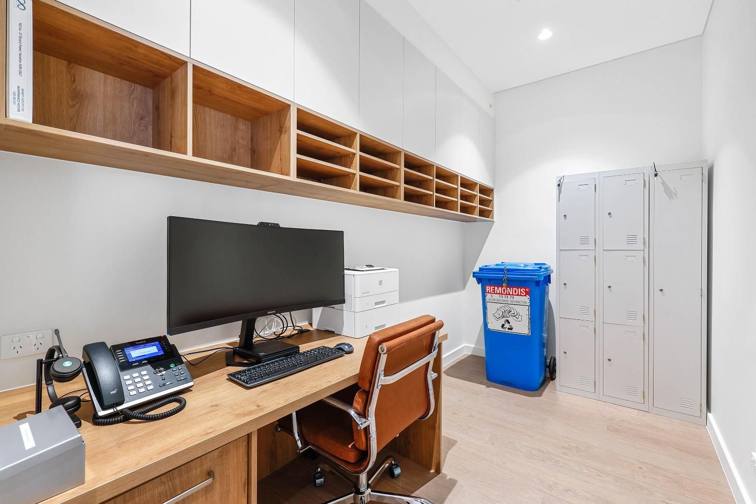 Office with Desk, Shelves, Lockers, and A Blue Recycling Bin — Above & Beyond Interiors Custom Joinery in Medical Centre, NSW