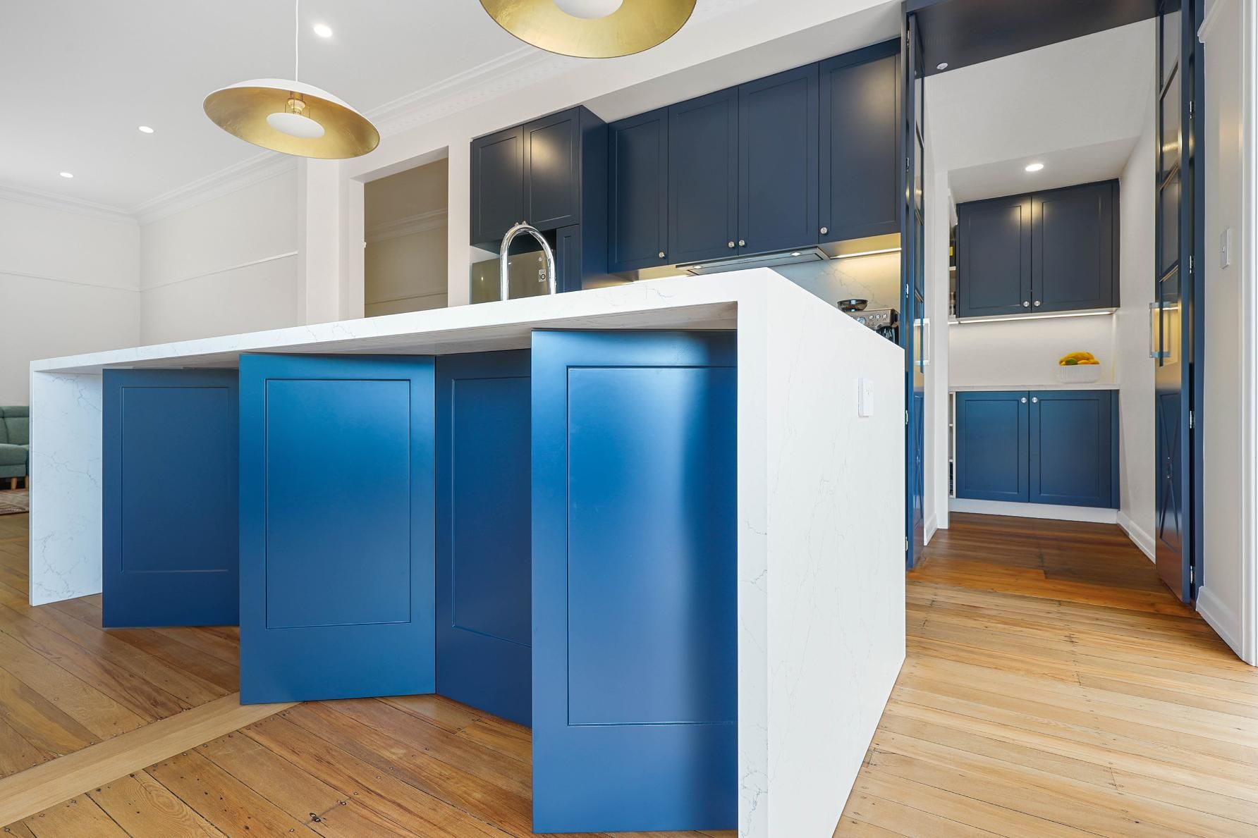 Blue and White Modern Kitchen with Island and Wood Floors, Gold Pendant Lights — Above & Beyond Interiors Custom Joinery in Lilyfield, NSW