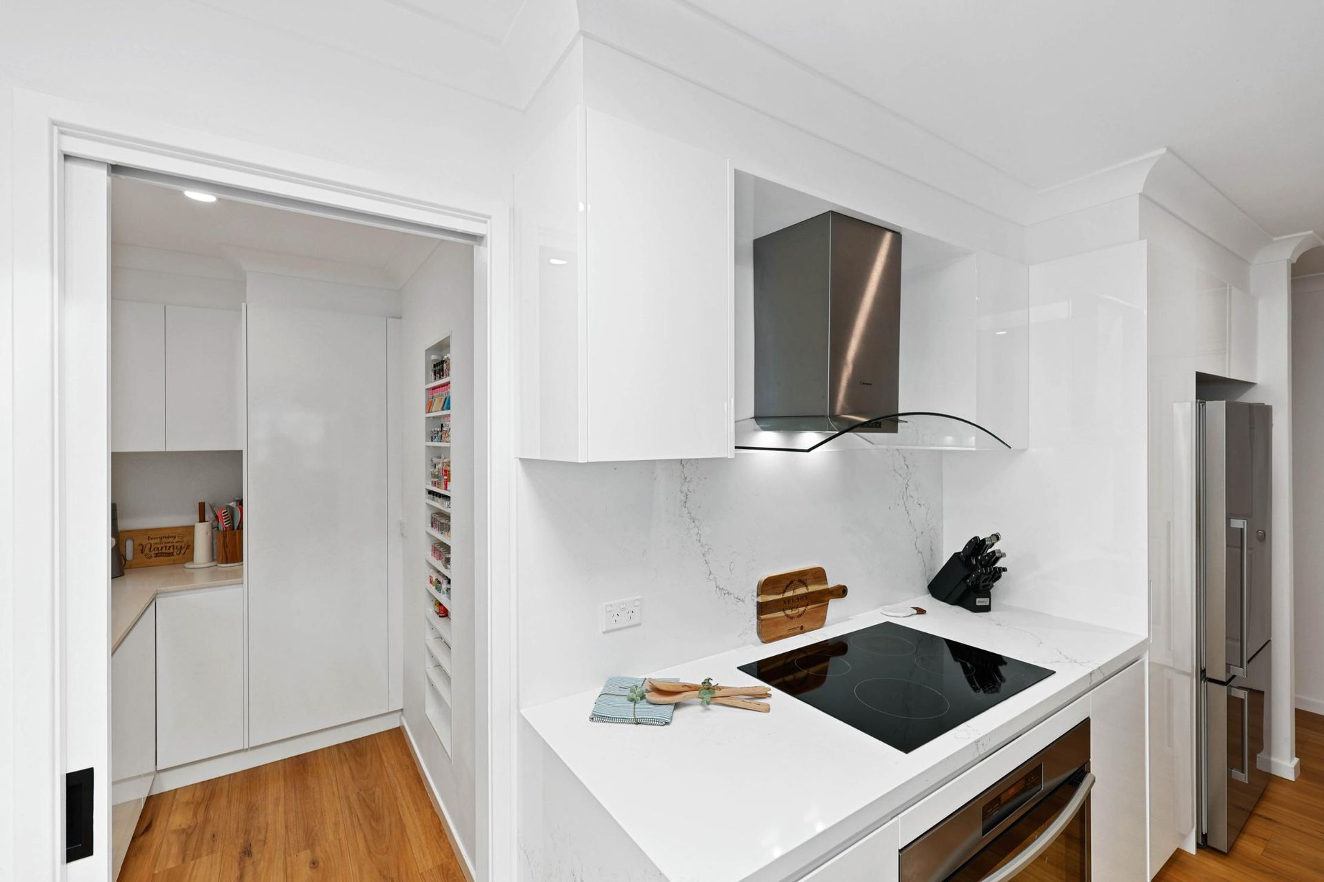 Bright White Modern Kitchen with Pantry; Stainless Steel Appliances, Wooden Floor — Above & Beyond Interiors Custom Joinery in Wattle Grove, NSW