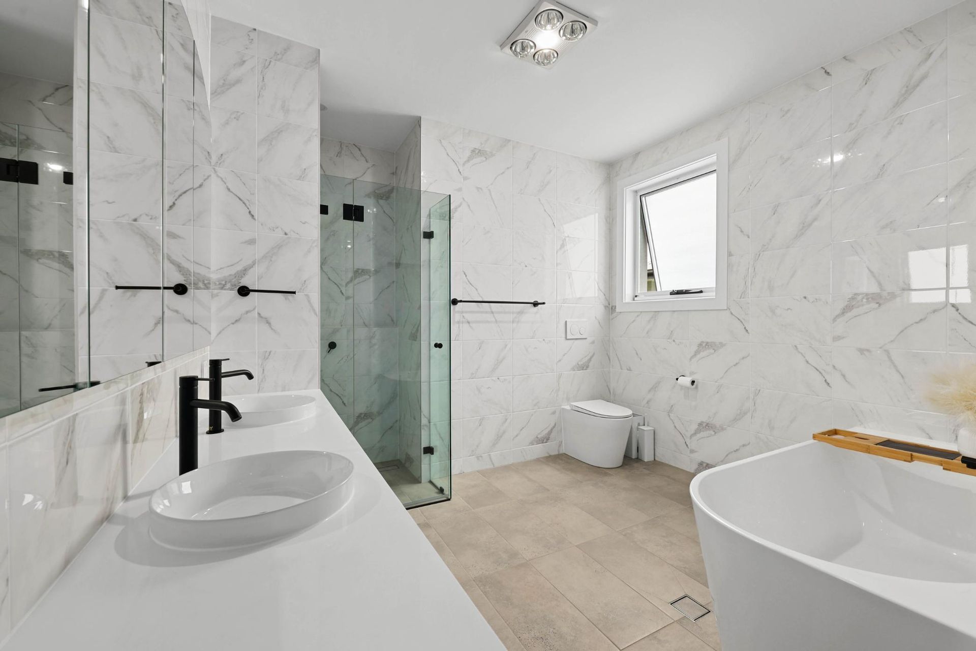 Luxurious White Marble Bathroom with Double Sinks, Glass Shower, and Freestanding Tub — Above & Beyond Interiors Custom Joinery in Currans Hill, NSW