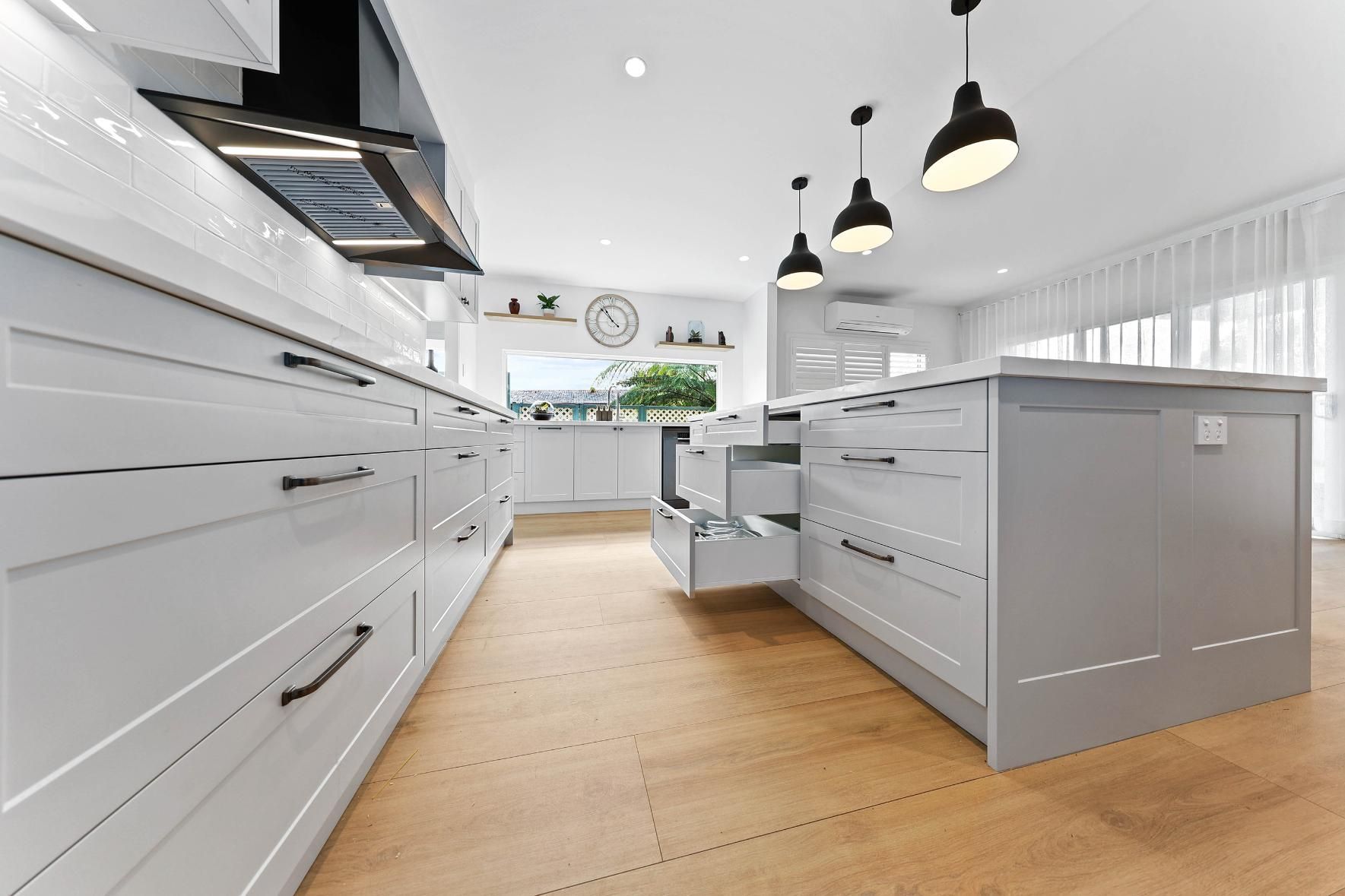 Modern Grey Kitchen with Wood Floors, Island, and Overhead Lighting — Above & Beyond Interiors Custom Joinery in Yowie Bay, NSW