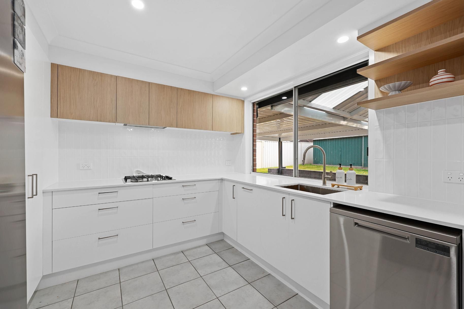 Modern Kitchen with White Cabinets, Wood Upper Cabinets, and A Stainless Steel Dishwasher — Above & Beyond Interiors Custom Joinery in Currans Hill, NSW