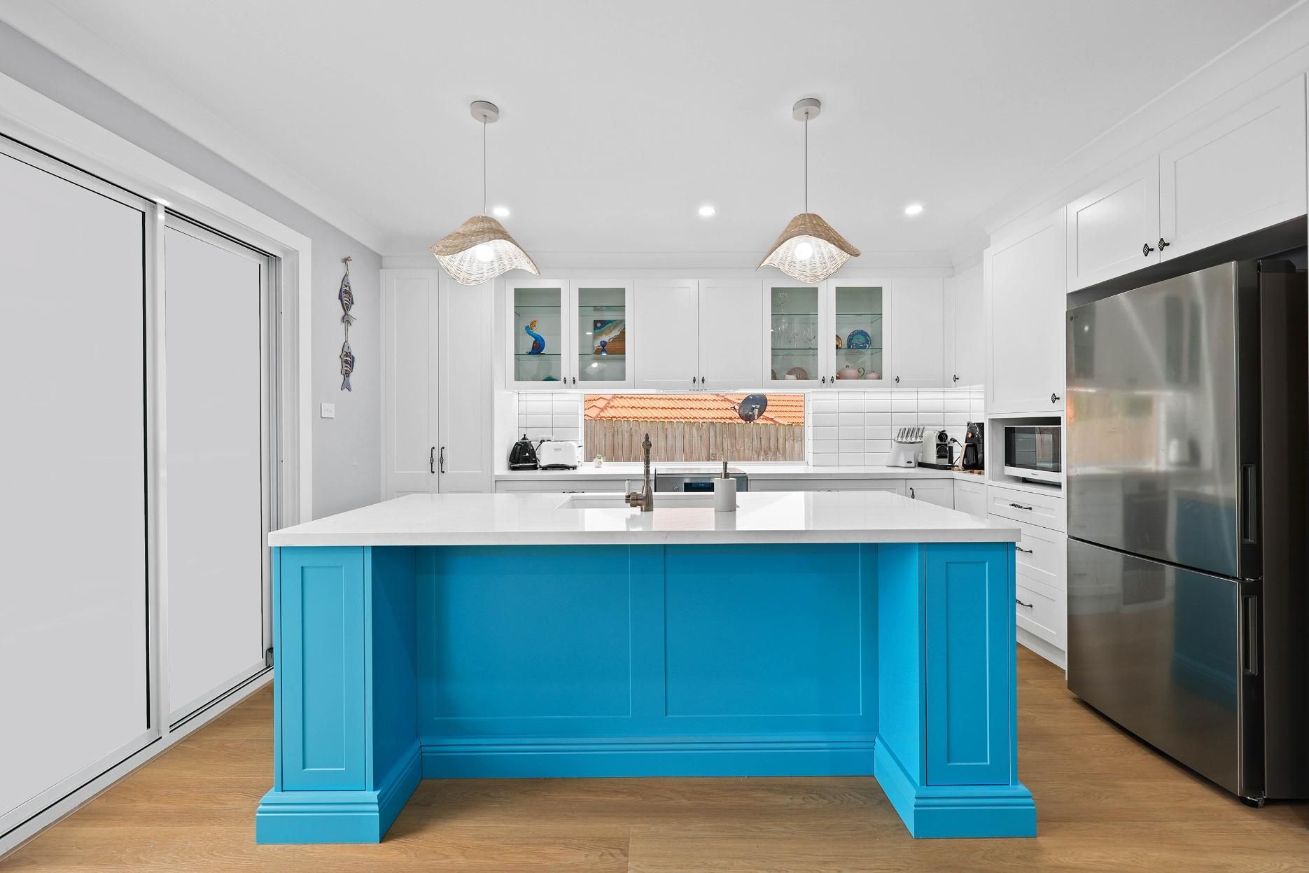 Bright Blue Kitchen Island with A White Countertop in A Modern Kitchen — Above & Beyond Interiors Custom Joinery in Gladsville, NSW