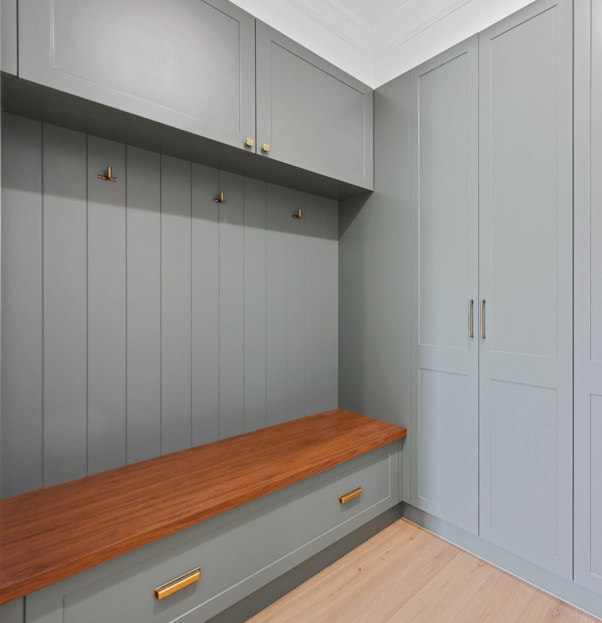 Mudroom with Built-In Storage, Grey Cabinets, Wood Bench and Floor, Brass Hardware — Above & Beyond Interiors Custom Joinery in Appin, NSW