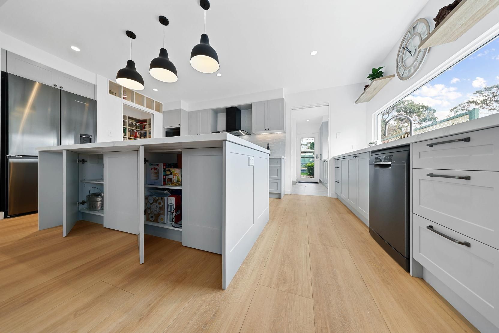 Modern Kitchen with Light Wood Floors, Grey Cabinets, and A Large Island with Storage — Above & Beyond Interiors Custom Joinery in Yowie Bay, NSW
