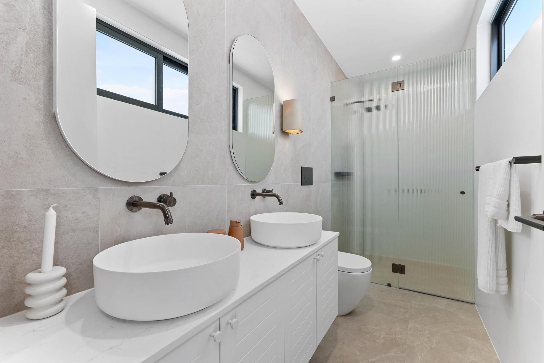 Modern Bathroom with White Sinks, Mirrors, and Shower. Grey Walls and Tile Floor — Above & Beyond Interiors Custom Joinery in Thirroul, NSW