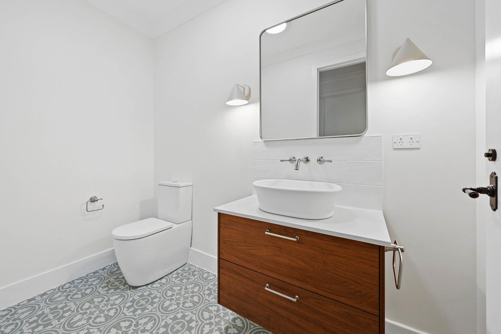 Modern Bathroom with A Floating Wooden Vanity, White Bowl Sink, and Patterned Floor Tiles — Above & Beyond Interiors Custom Joinery in Appin, NSW