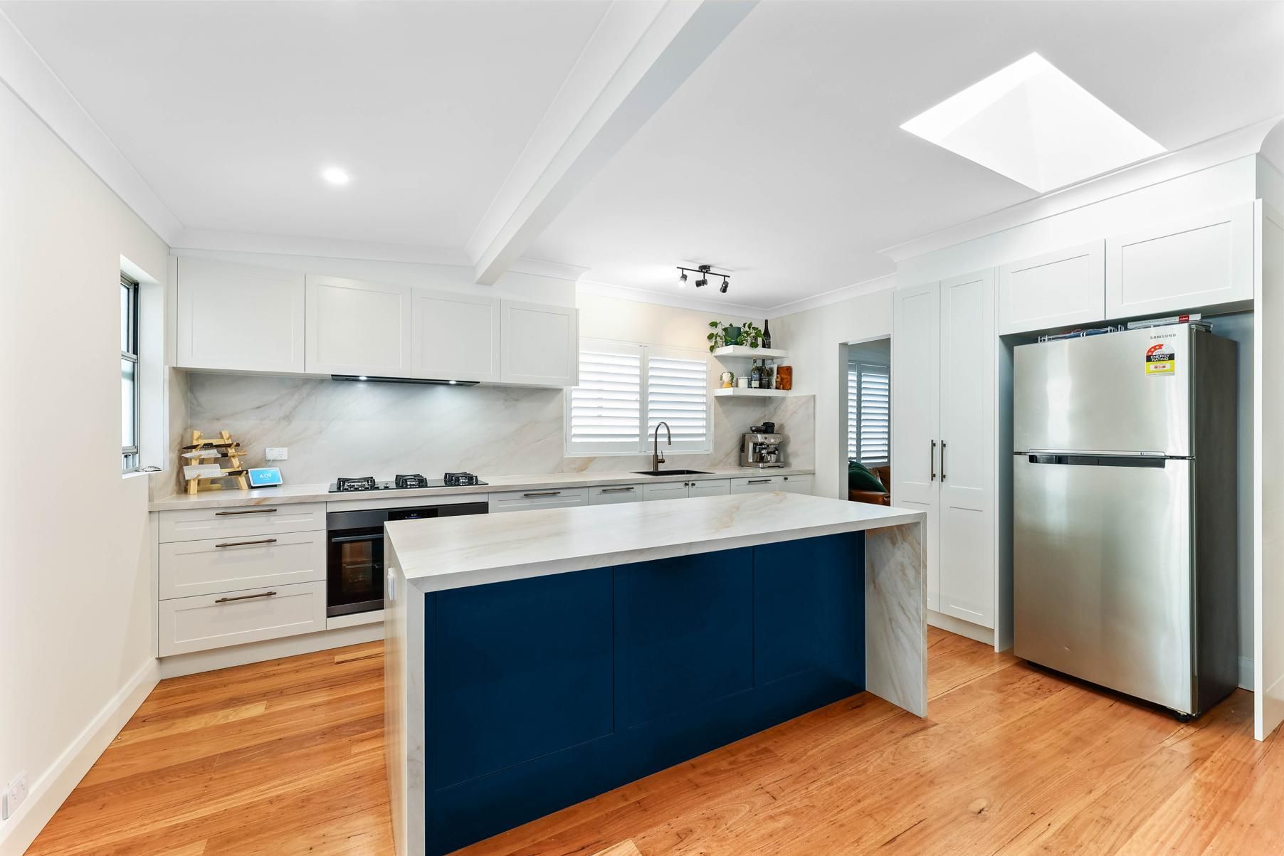Modern Kitchen with White Cabinets, Blue Island, Wooden Floor — Above & Beyond Interiors Custom Joinery in Bellambi, NSW