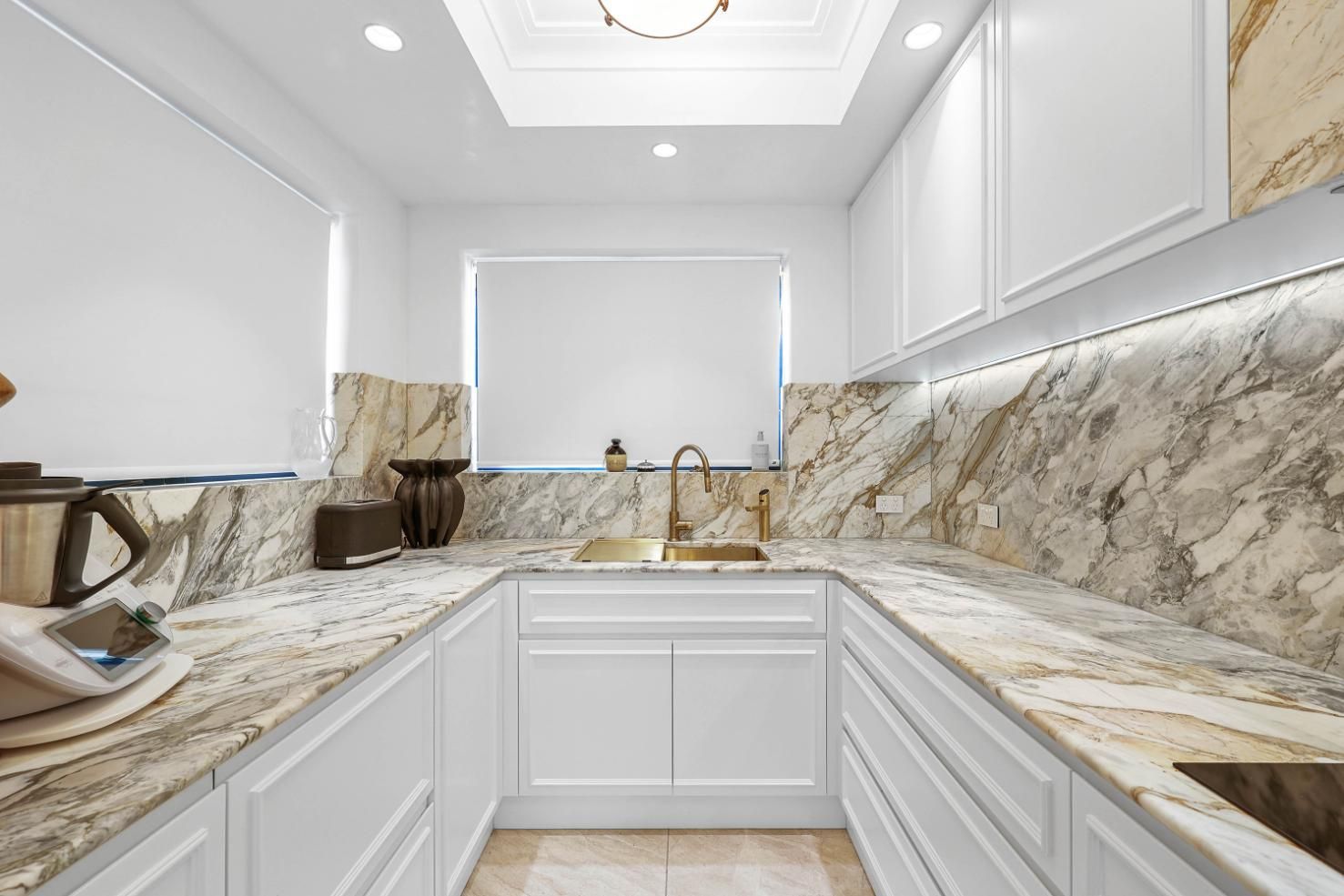 White and Granite Kitchen with Cabinets, Countertops, Sink, and Window — Above & Beyond Interiors Custom Joinery in Double Bay, NSW