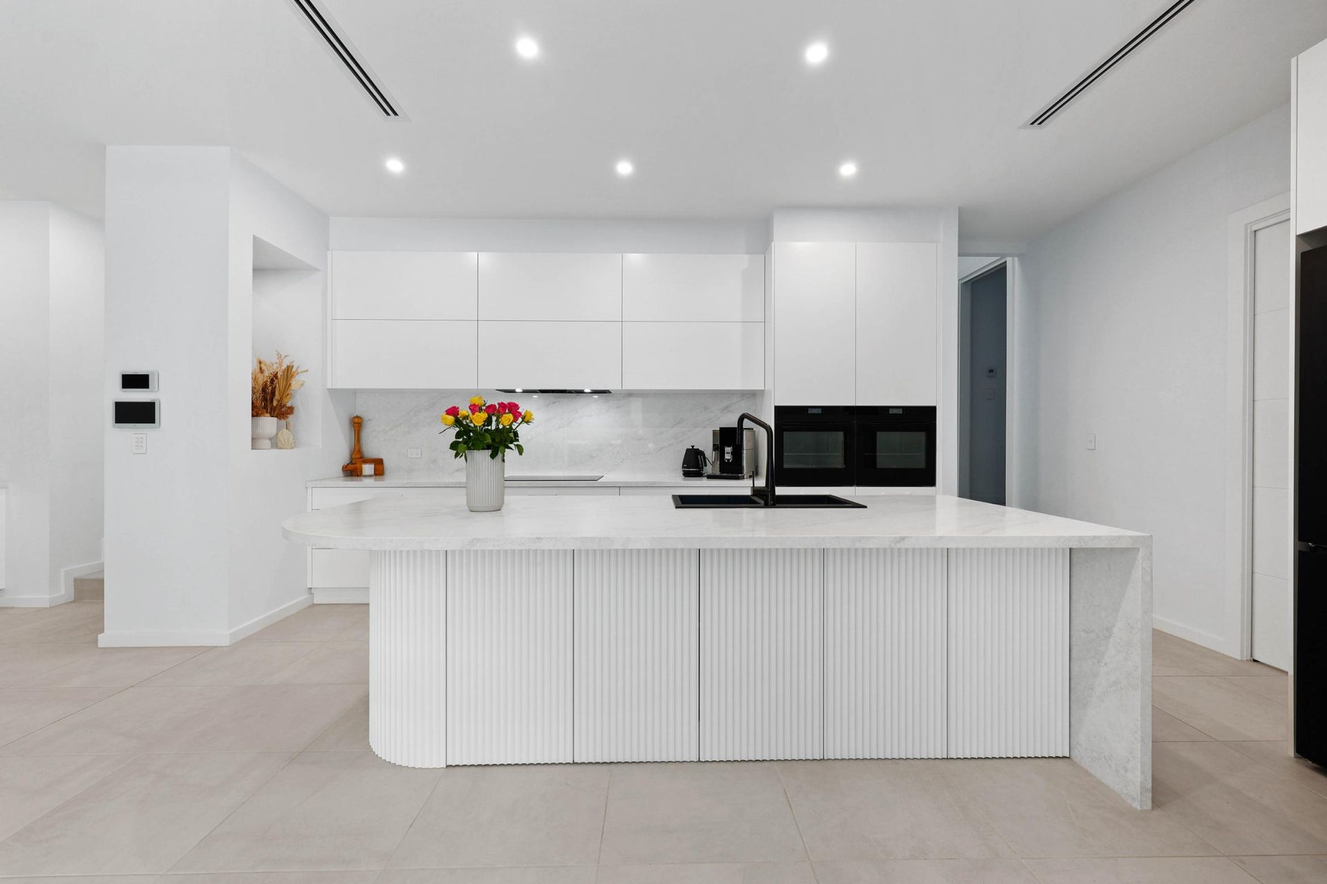 Modern White Kitchen with Island, Cabinetry, Appliances, and Light Wood Floors — Above & Beyond Interiors Custom Joinery in Currans Hill, NSW