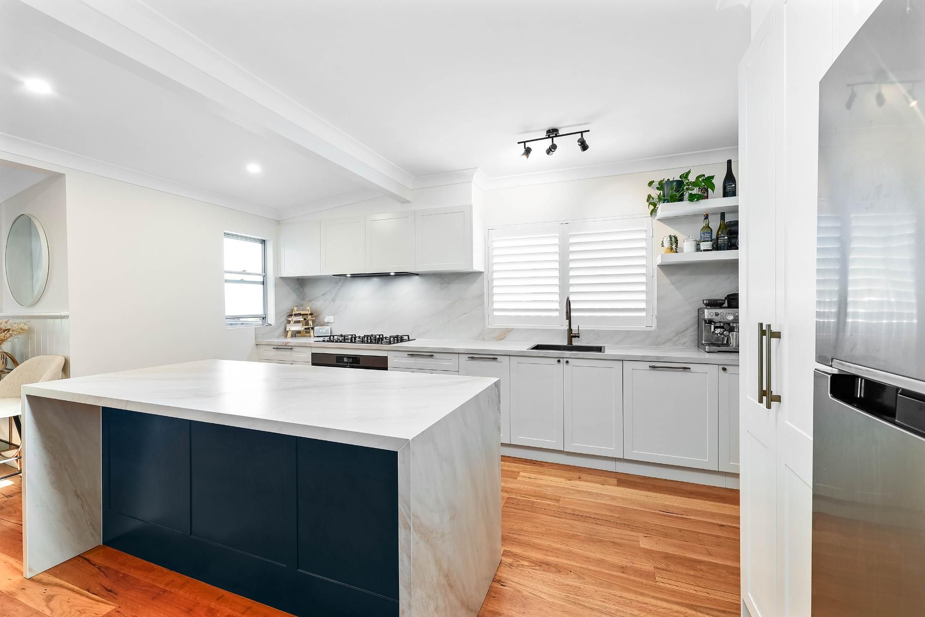 Modern Kitchen with White Cabinets, Blue Island, Wooden Floor — Above & Beyond Interiors Custom Joinery in Bellambi, NSW