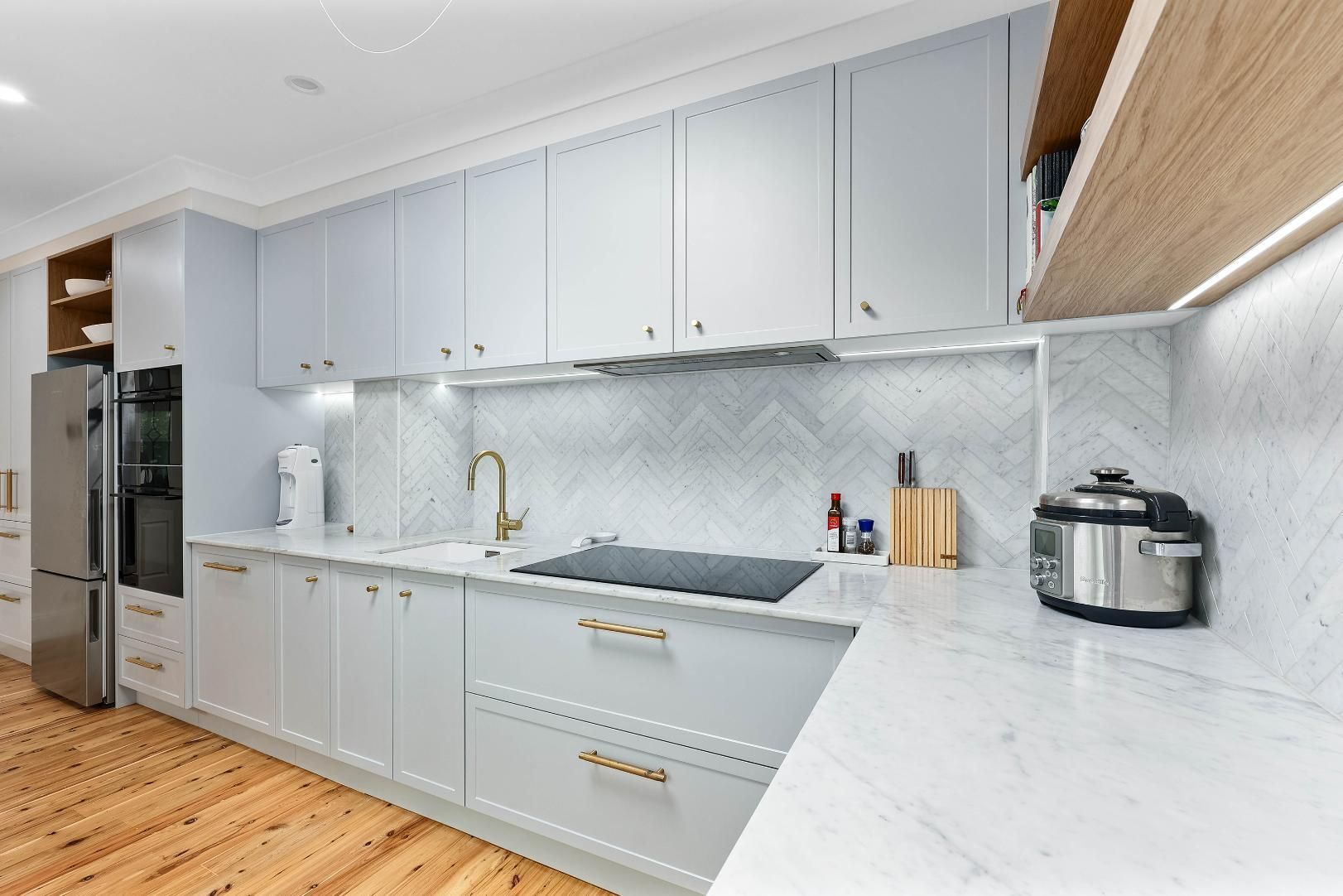 Light Blue Kitchen Cabinets with Marble Countertops and Gold Fixtures — Above & Beyond Interiors Custom Joinery in Erskineville, NSW