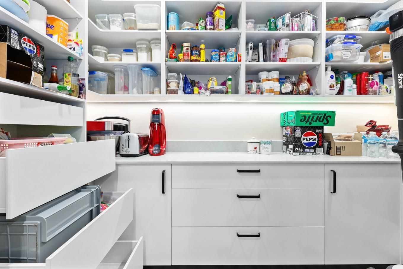White Pantry with Shelves of Food and Supplies, Drawers, and Countertop with Appliances — Above & Beyond Interiors Custom Joinery in Bradbury, NSW