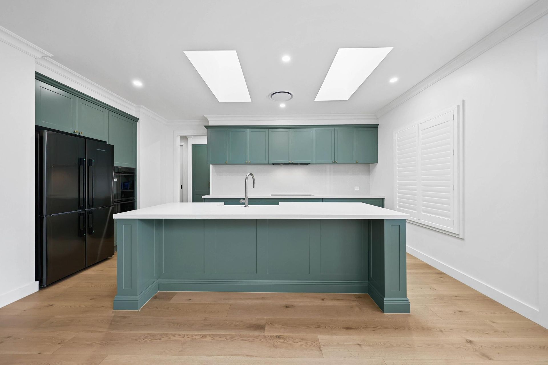 Modern Kitchen with Teal Cabinets, White Countertops, Island, and Light Wood Floor — Above & Beyond Interiors Custom Joinery in Appin, NSW