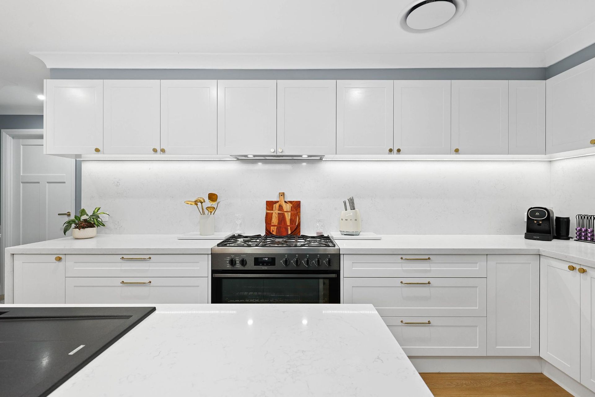 White Kitchen with Overhead Cabinets, Quartz Countertops, and Stainless Steel Appliances — Above & Beyond Interiors Custom Joinery in Harrington Park, NSW